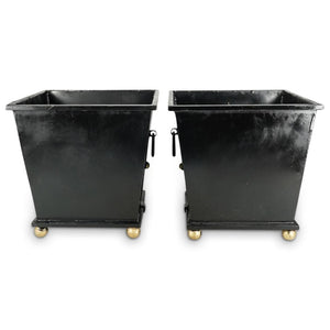 PAIR OF METAL FOOTED PLANTERS WITH BLACK FINISH, TWO LATERAL HANDLES AND EMBELLISHED WITH GILT PAINTED ACCENTS