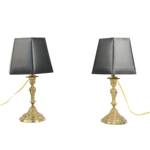 A PAIR OF ANTIQUE BRONZE ELECTRIFIED CANDLESTICK LAMPS