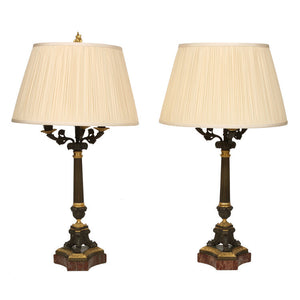 A PAIR OF FRENCH NAPOLEON BRONZE AND GILT METAL CANDLESTICK LAMPS WITH SILK SHADES