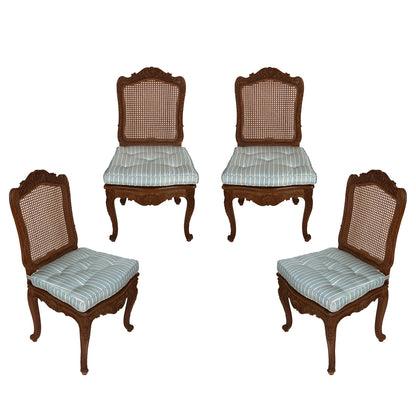 SET OF FOUR CARVED FRENCH CHAIRS WITH CANE BACK AND BLUE SILK STRIPE CUSHIONS