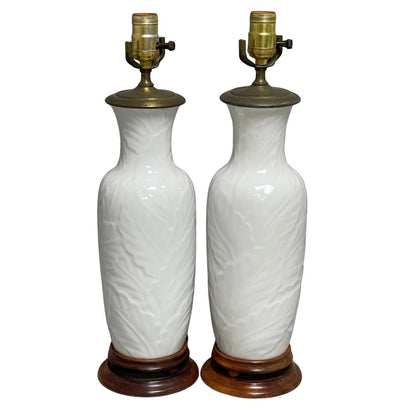 PAIR OF WHITE PORCELAIN TABLE LAMPS IN PALM LEAF RELIEF
