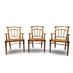 SET OF THREE HAND CARVED MAPLE  AND CANE ARMCHAIRS