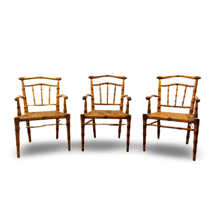 SET OF THREE HAND CARVED MAPLE  AND CANE ARMCHAIRS