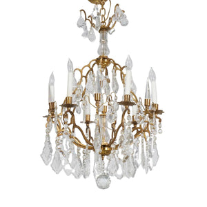 LOUIS XV STYLE TWELVE ARM BRASS AND FACETED CRYSTAL CHANDELIER