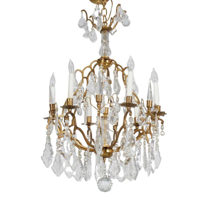 LOUIS XV STYLE TWELVE ARM BRASS AND FACETED CRYSTAL CHANDELIER
