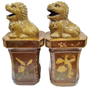 PAIR OF GLAZED OCHRE FOO DOGS ON PEDESTALS