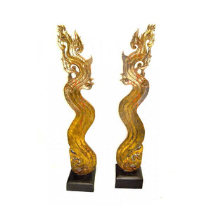 PAIR OF GILT WOOD ASIAN NAGA SCULPTURES ON EBONIZED BASES