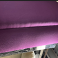 UPHOLSTERED AUBERGINE BANQUETTE WITH MIRRORED BASE